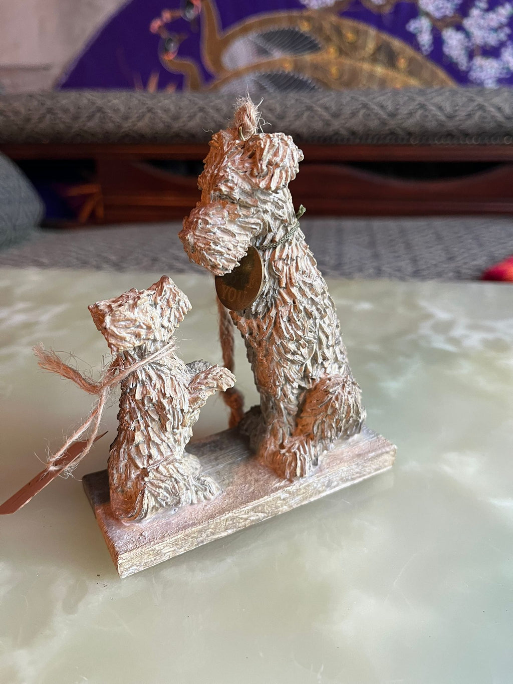 A charming decorative statue depicting two terriers