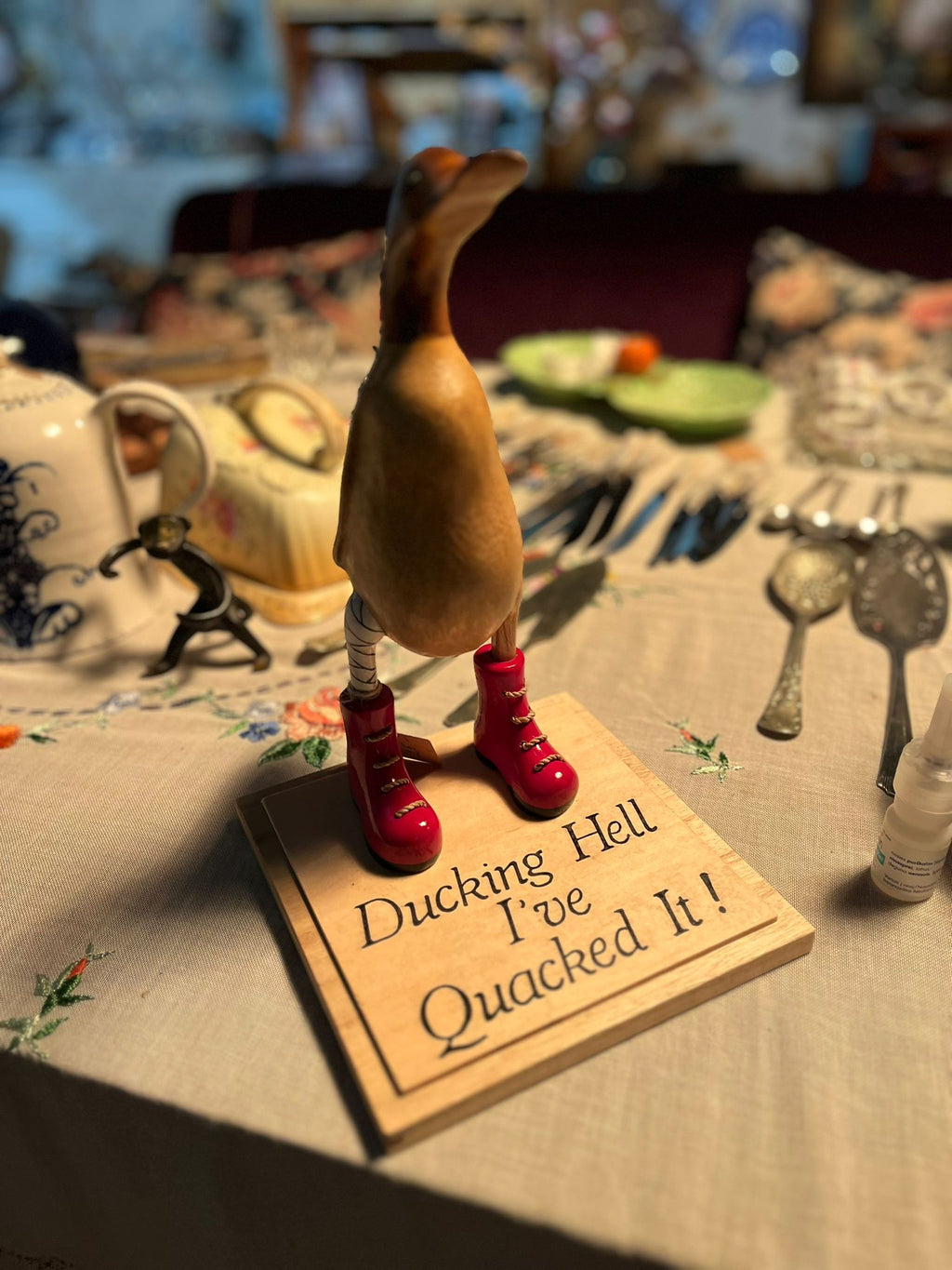 Hand-carved wooden duck with boots