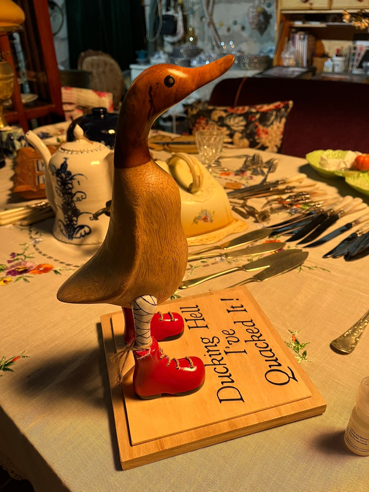 Hand-carved wooden duck with boots