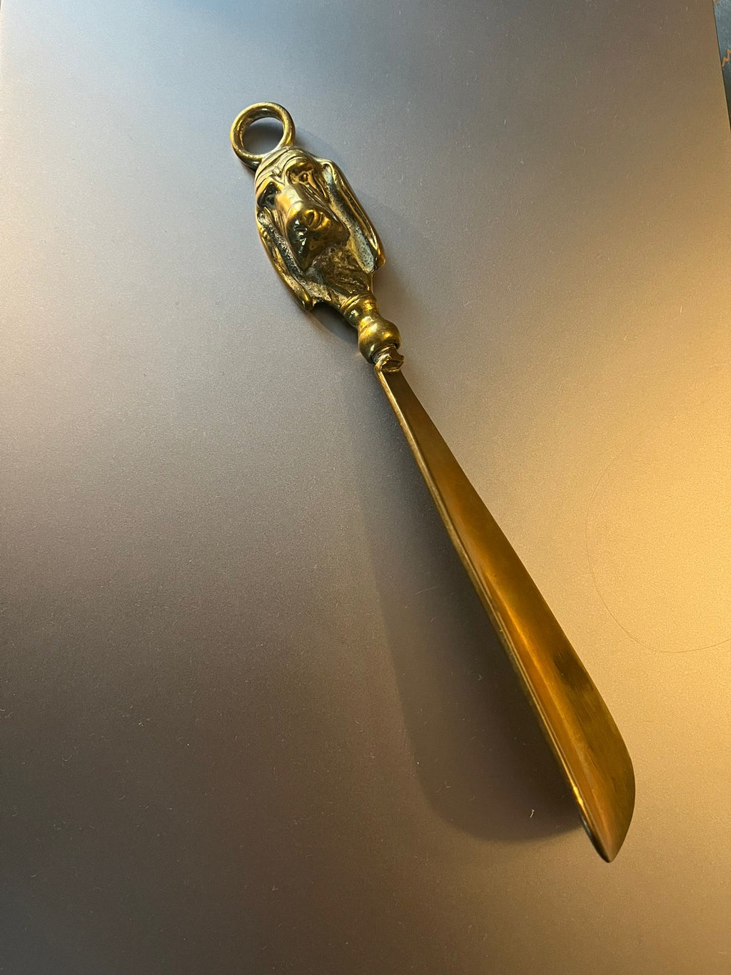 Vintage brass shoehorn with dog head handle