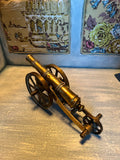 Old brass cannon model – a nautical and military-themed interior design element