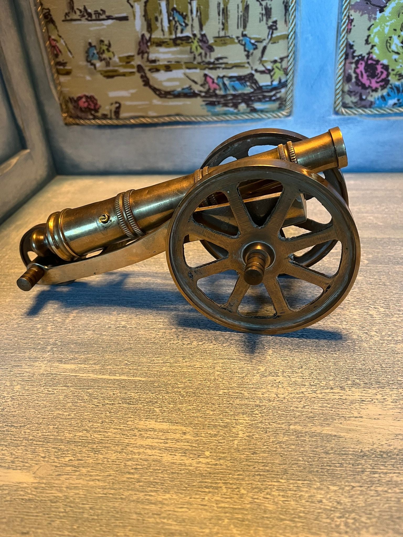 Old brass cannon model – a nautical and military-themed interior design element