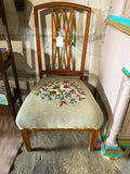 Vintage embroidered chair with brass wheels