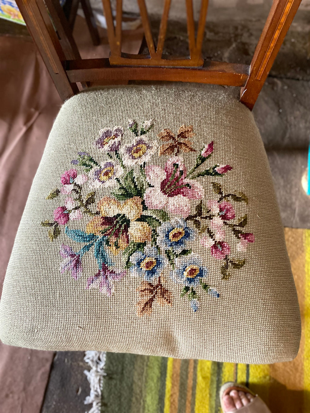 Vintage embroidered chair with brass wheels