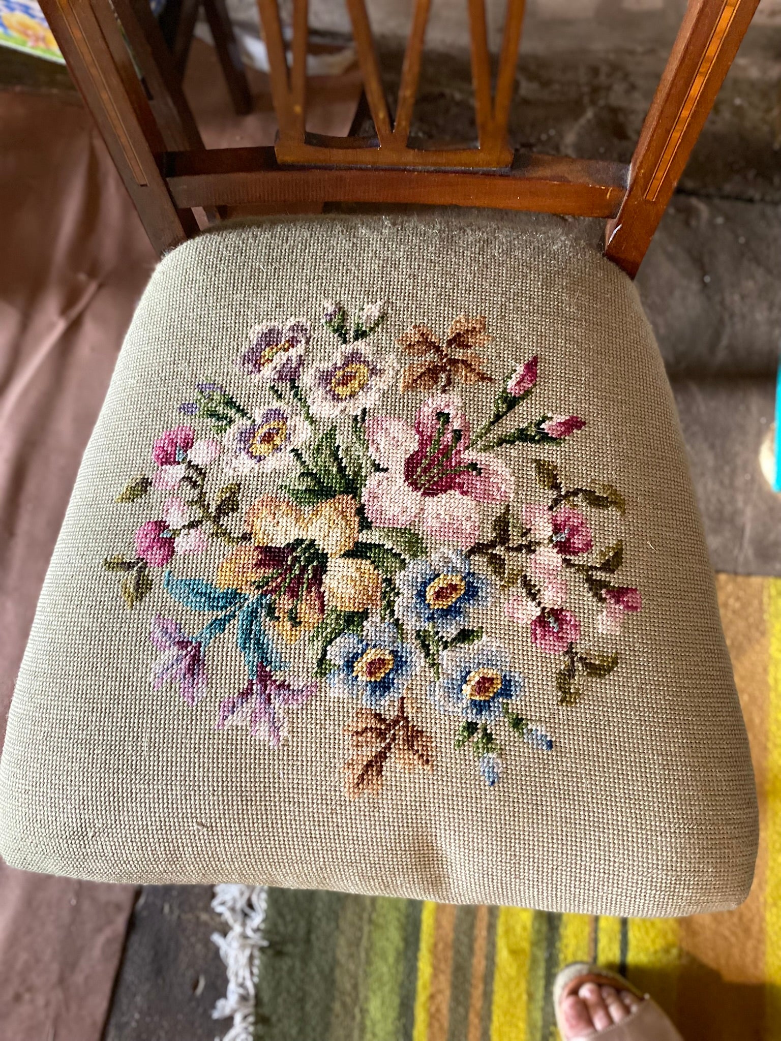 Vintage embroidered chair with brass wheels