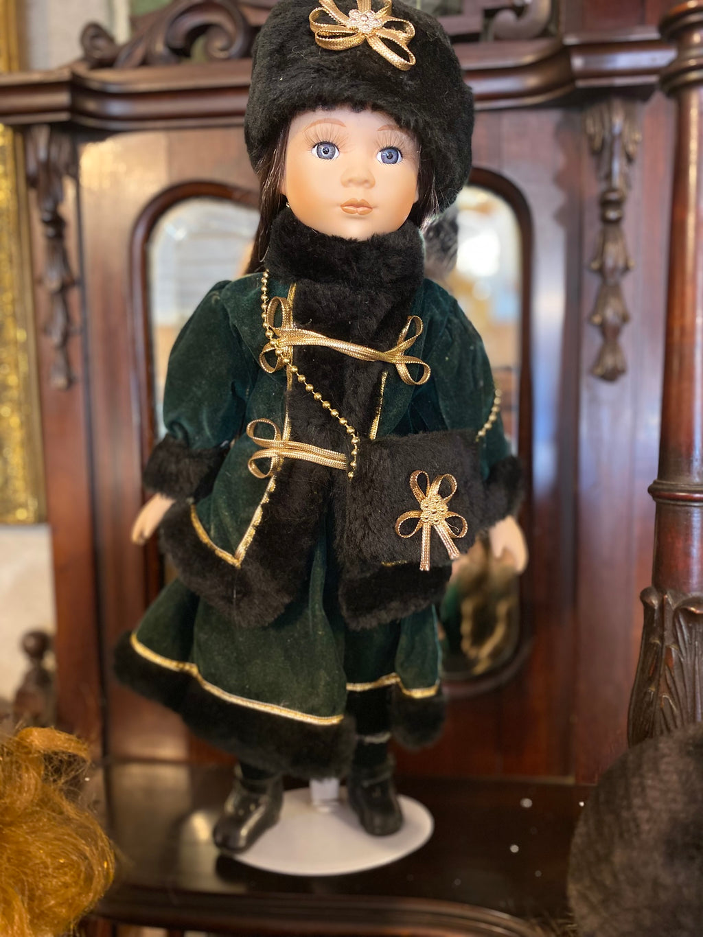 Vintage porcelain doll with elegant winter clothing
