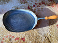 Old oval copper pan with wooden handle