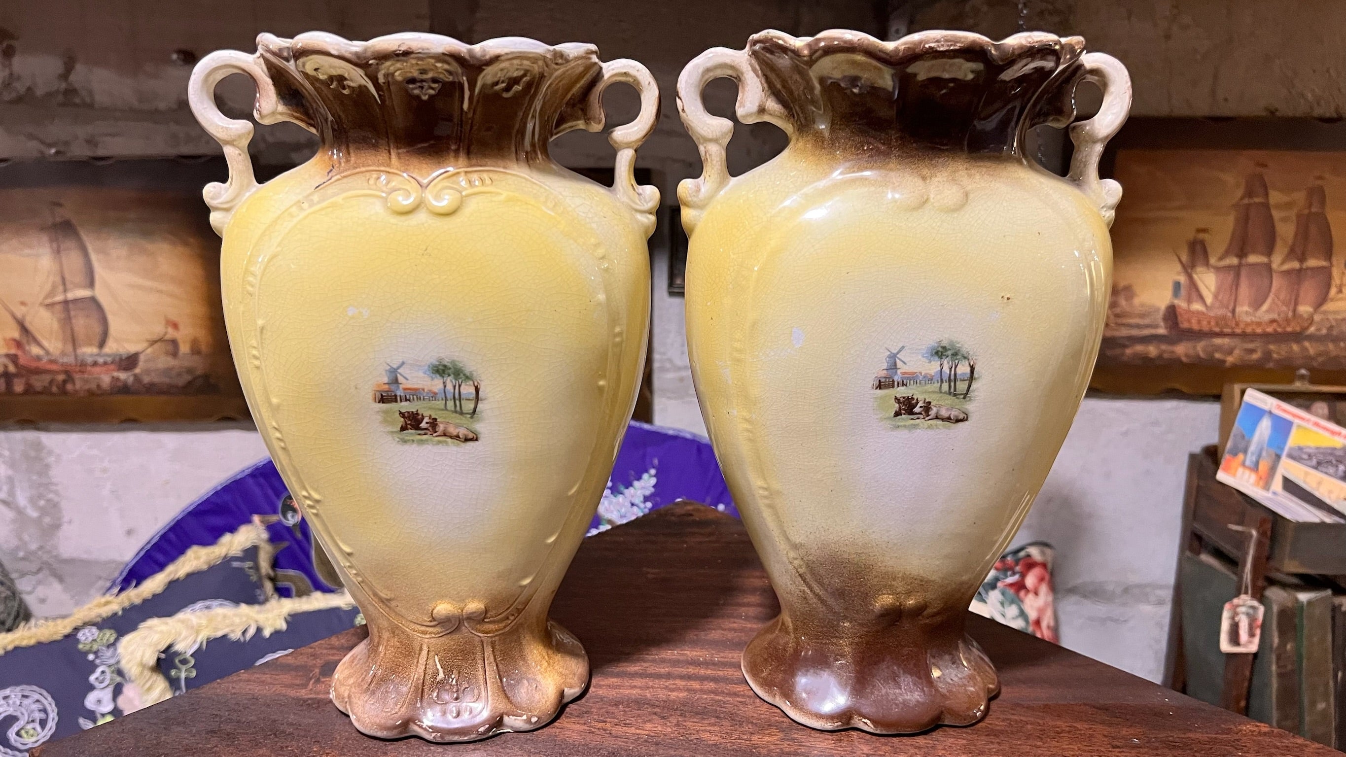 Pair of antique hand-painted ceramic vases with landscape views
