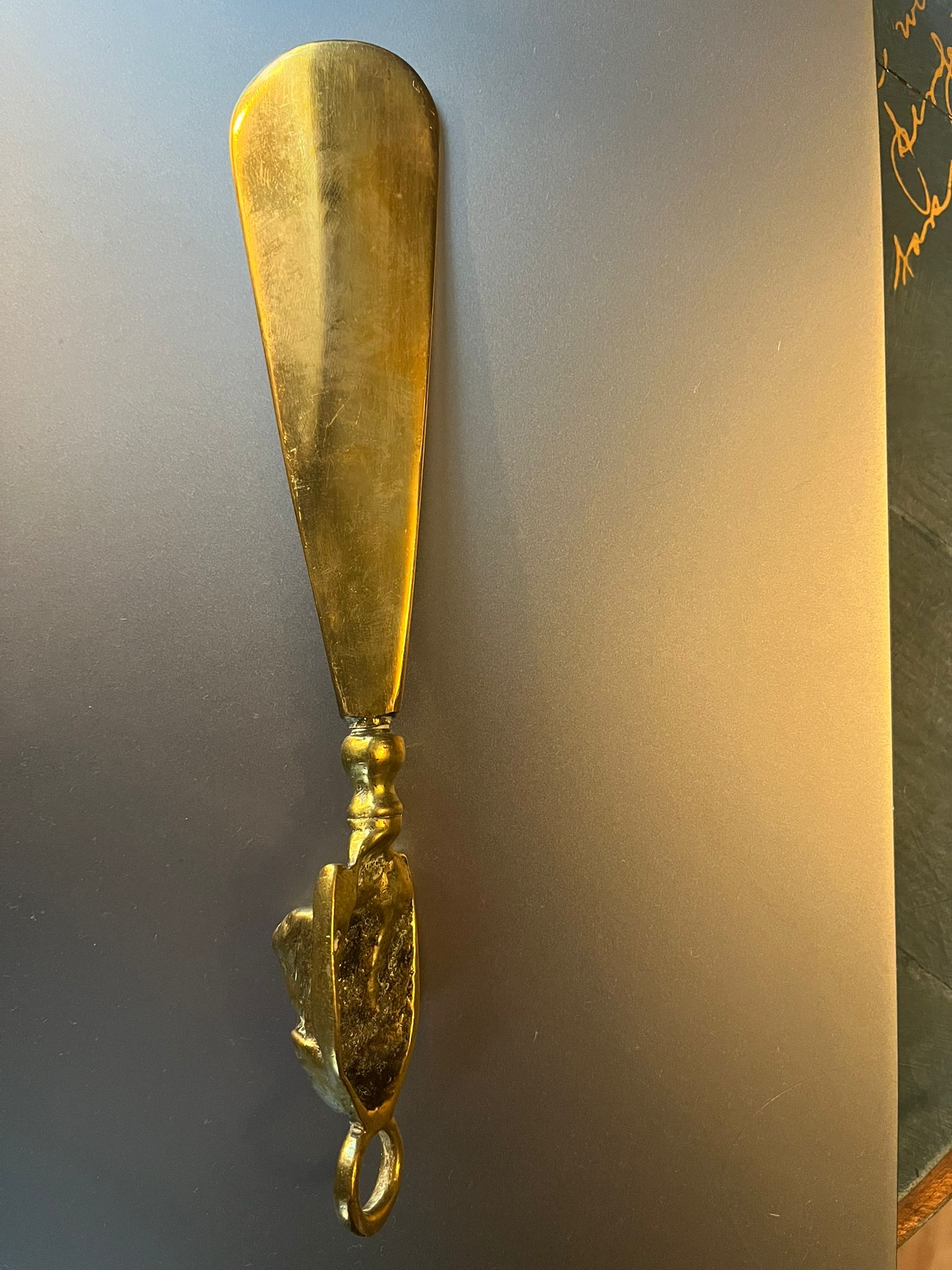 Vintage brass shoehorn with dog head handle